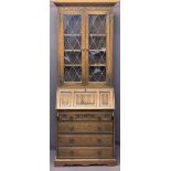 OLD CHARM OAK BUREAU BOOKCASE - leaded glass upper doors and carved linenfold detail to the floor,