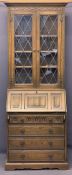 OLD CHARM OAK BUREAU BOOKCASE - leaded glass upper doors and carved linenfold detail to the floor,