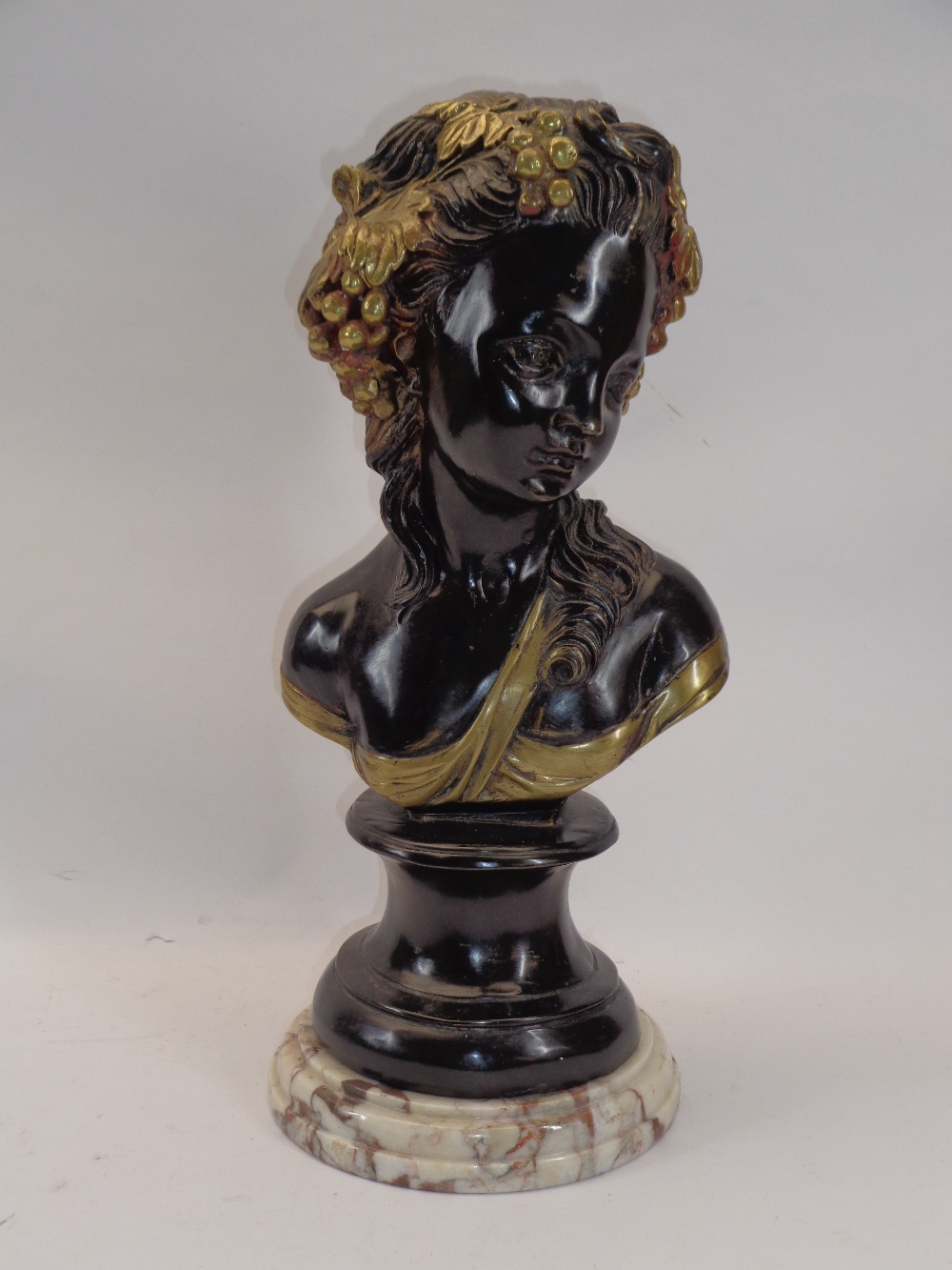 REPRODUCTION BRONZE & GILT HIGHLIGHTED BUST - a young maiden with fruit and vines in her hair on a