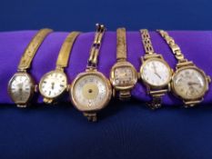 LADY'S 9CT GOLD WRISTWATCHES (6) - five being 9ct gold cased with plated bracelet straps, the