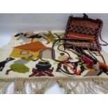 TRIBAL WOOLWORK WALL HANGING, vintage carpet type bag and a leather whip, 120 x 84cms the wall