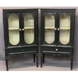ANTIQUE STYLE EBONISED TWIN-DOOR DISPLAY CABINETS, A PAIR - having bevel edged glass and pottery