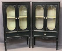 ANTIQUE STYLE EBONISED TWIN-DOOR DISPLAY CABINETS, A PAIR - having bevel edged glass and pottery