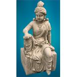 GARDEN STONEWARE - reconstituted statuary depicting an Indian deity seated upon a rectangular block,
