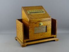 AN OAK STATIONERY/LETTER BOX with brass posting aperture and escutcheon, 27.5cms H, 32cms W