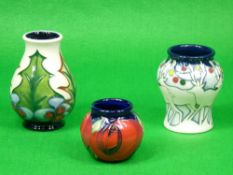 MOORCROFT 'Red Rose, Holly and Berry and Lapland vases' - the first being Cobalt ground by Emma