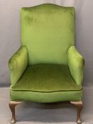 VINTAGE UPHOLSTERED ARMCHAIR IN GREEN - on Queen Anne front supports with brown pot rear castors,