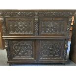 CONTINENTAL CARVED OAK CUPBOARD - of good colour having two top drawers with seahorse and mask