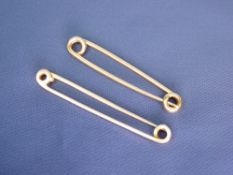 TWO PLAIN OBLONG TIE PINS - one marked 9ct, 3.8grms and the other unmarked but believed gold, 3.