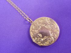 A 9CT GOLD CIRCULAR PHOTO LOCKET - floral scrolled front, plain back and fine link chain, 10grms