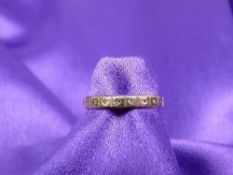 A LADY'S 9CT GOLD ETERNITY RING - with tiny diamond chippings, 1.8grms gross