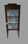 EDWARDIAN CHINA CABINET with single glazed door on spade feet and with railback, 152cms H, 60cms