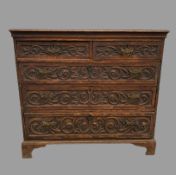 CHEST OF DRAWERS - period oak with carved front with three long and two short drawers on bracket