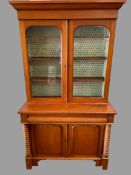 ANTIQUE MAHOGANY BOOKCASE CUPBOARD or 'Cwpwrdd Gwydr', having a base section with turned pillars and
