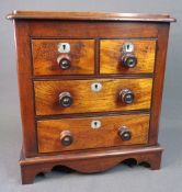 APPRENTICE CHEST of two long and two short drawers, on bracket feet with turned knobs and mother