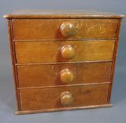 VINTAGE DESKTOP FOUR DRAWER CHEST with turned knobs, 29cms H, 32cms W, 28cms D