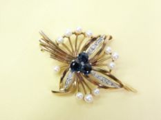 A 9CT GOLD LEAF/FLORAL BROOCH - three central sapphires (or similar) with three diamond encrusted