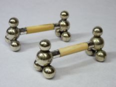 SILVER & IVORY KNIFE RESTS (A PAIR) - the end being four silver ball supports with centre ivory bar,