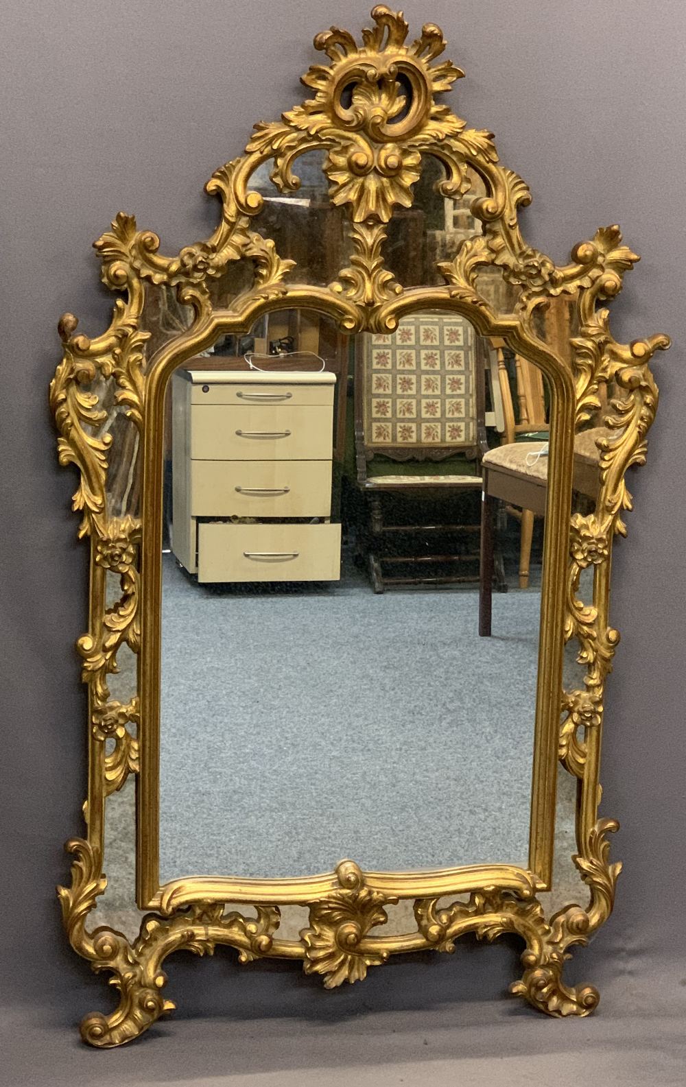 ROCOCO STYLE GILT FRAMED OVERMANTEL MIRROR - the pierced moulding having numerous mirrored panels