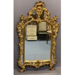 ROCOCO STYLE GILT FRAMED OVERMANTEL MIRROR - the pierced moulding having numerous mirrored panels