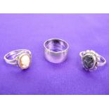 A 1973 WIDE SILVER SIGNET RING - 7.2grms, and two lady's silver dress rings, 6.3grms