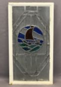 METAL FRAMED LEADED GLASS WINDOW PANEL - central circular coloured depiction of a yacht, 90.5cms
