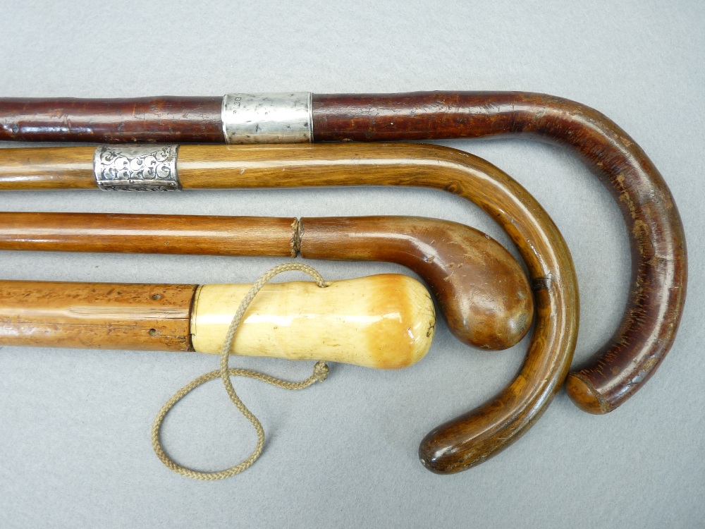 ANTIQUE & LATER WALKING STICKS & CANES (4) including a Malacca example with possibly walrus ivory