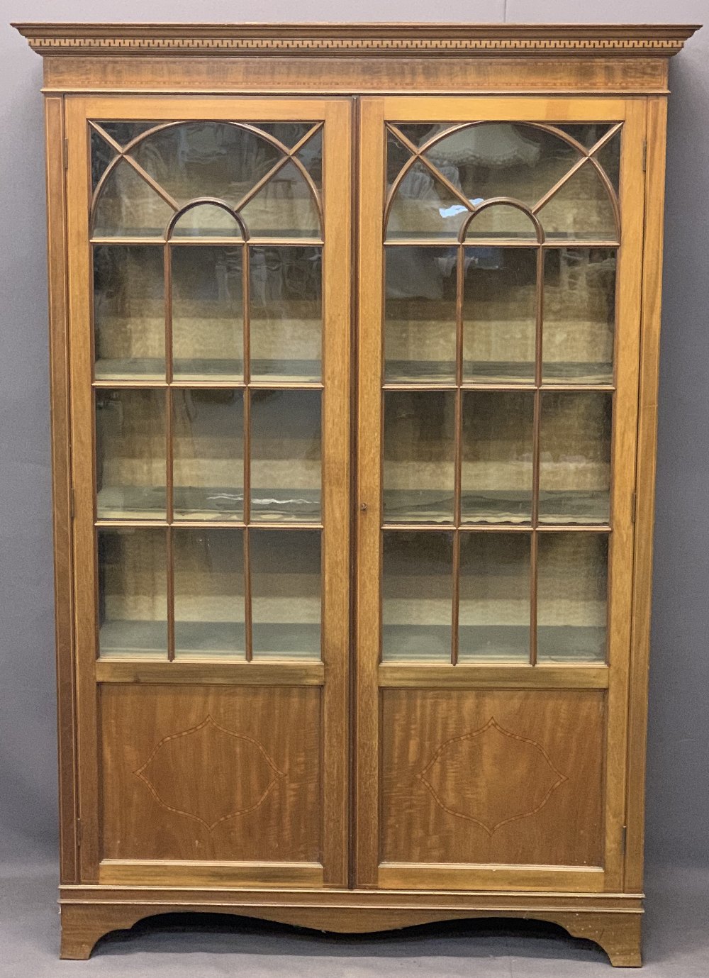 CIRCA 1900 MAHOGANY TWO DOOR CHINA DISPLAY CABINET - with dentil detail to the cornice and string