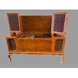 DYNATRON RADIOGRAM with a pair of floor standing speakers, in a walnut effect cabinet, 75cms H,