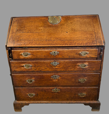 BUREAU - Georgian oak having a sloped front with large brass lock plate revealing a centre open