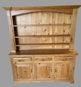 PINE DRESSER with a three shelf rack to the upper section and the base having three drawers over