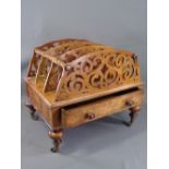 VICTORIAN CANTERBURY in walnut, three divisional fretwork sections with base drawer, on turned