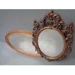 MIRRORS (two) - a gilt framed oval with bevelled glass, 57 x 93cms and an ornate mirror