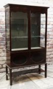 EARLY 20TH CENTURY MAHOGANY CHINA CABINET, shaped doors and glazed sides, cupboards under and