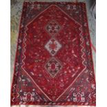 QASHQAI RUG, triple joined lozenges to the hexagonal red floral field, blue-grey floral spandrels,