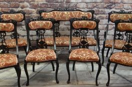 EARLY 20TH CENTURY EBONISED SALON SUITE, carved cresting rails and splats, comprising settee, two