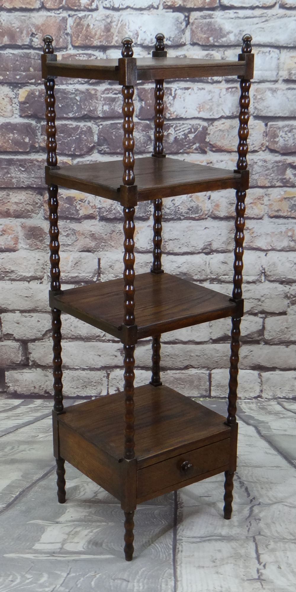 REPRODUCTION OAK FOUR-TIER WHATNOT with drawer base, tiers separated by bobbin turned uprights,