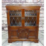 REPRODUCTION OAK BOOKCASE, probably 'Old Charm', with leaded glass cupboard top and panelled base on