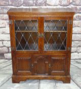 REPRODUCTION OAK BOOKCASE, probably 'Old Charm', with leaded glass cupboard top and panelled base on