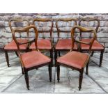 SET OF SIX VICTORIAN WALNUT BUCKLE BACK DINING CHAIRS with scroll carved cross bars and moulded seat