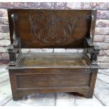 REPRODUCTION OAK MONK'S BENCH, lions carved arms and carved shiled top, 107cms wide