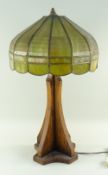 ARTS & CRAFTS MISSION-STYLE OAK TABLE LAMP, domed segmented green glass shade on a cruciform section