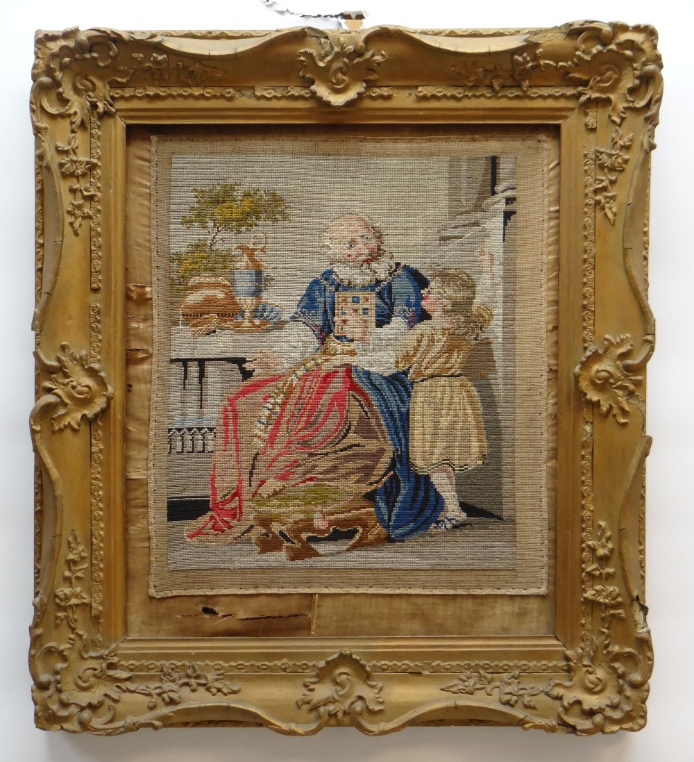 VICTORIAN WOOLWORK PICTURE, embroidered with an elderly bearded gentleman and chid beside a table
