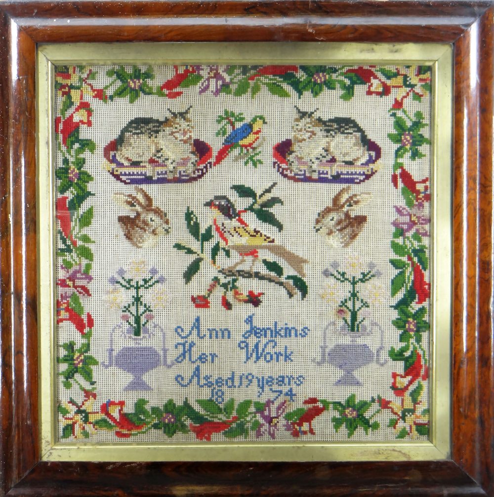 19TH CENTURY SAMPLER depicting birds, seated cats on cushions, hare heads, floral vases, all