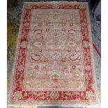 OUSHAK RUG, allover floral salmon field within dark pink palmette border and narrow guards, 275 x