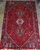 QASHQAI RUG, triple joined lozenges to the hexagonal red floral field, blue-grey floral spandrels,