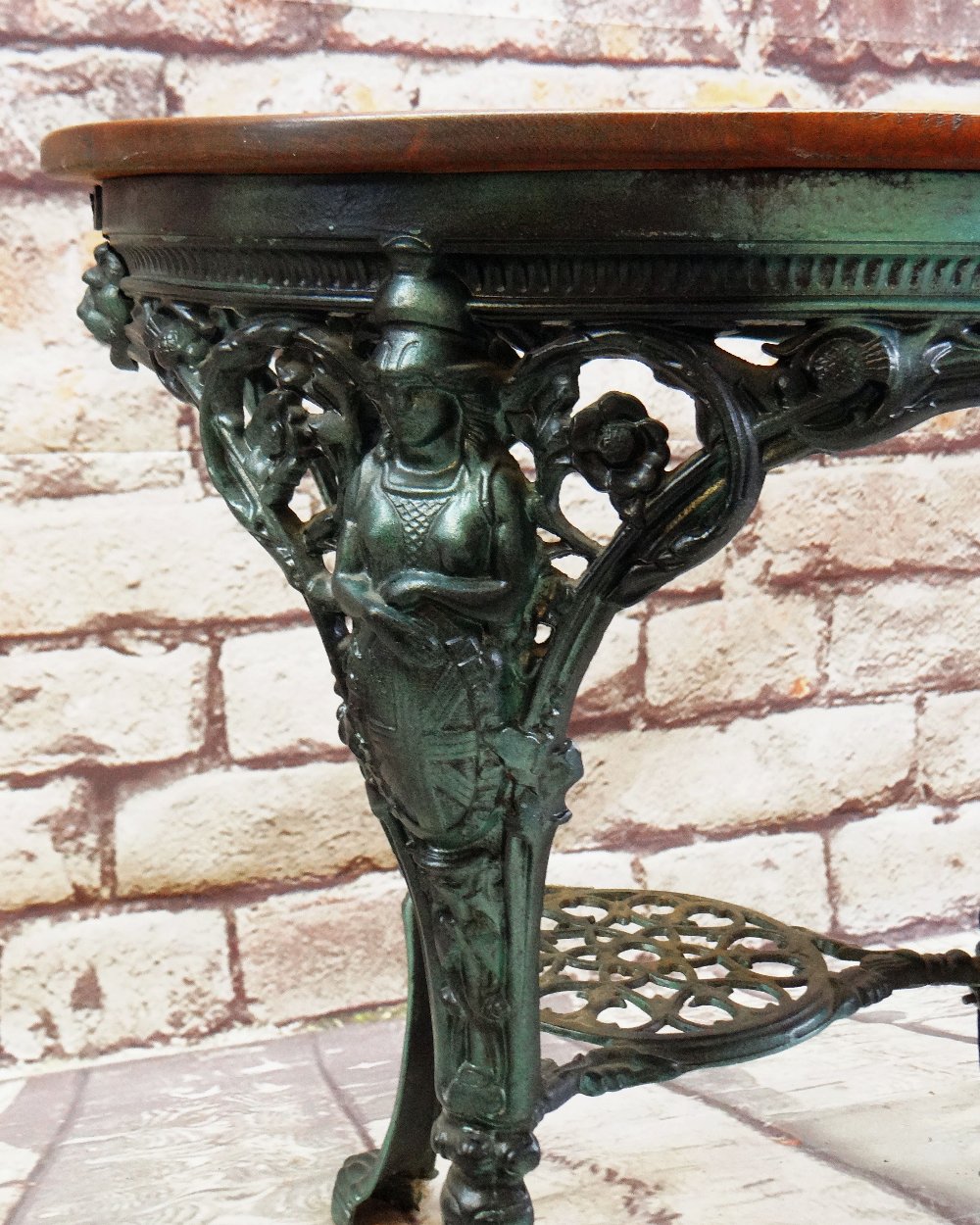 MODERN VICTORIAN-STYLE METAL & STAINED WOOD PUB TABLE, legs pierced and cast with Britannia, llion's