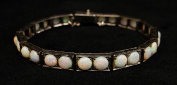 WITHDRAWN - WHITE METAL OPAL SET BRACELET, of rectangular tablet design, twenty-eight graduated op