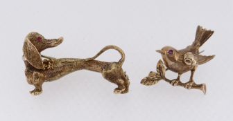 GOLD & RUBY ANIMAL BAR BROOCHES comprising 18ct gold dog brooch, 9.7gms, and a 9ct gold bird brooch,