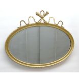 VICTORIAN OVAL MIRROR, gilt gesso frame with ribbon and trophy cresting, 74 x 94cms